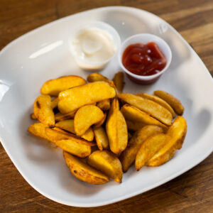 Golden fried Potato Wedges served with two dips, showcasing Eastbourne's expertise in comfort food.