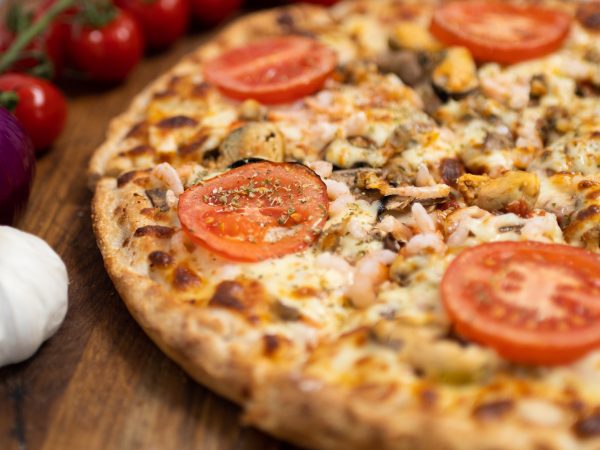 Flavor-packed Seafood Pizza with prawns, cockles, and mussels in Eastbourne